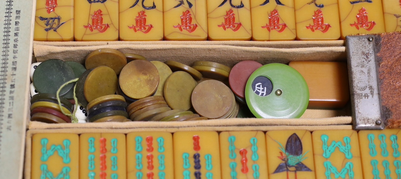 A leather cased Bakelite mahjong set